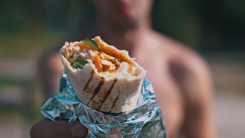 Shawarma in foil on a green background Stock Footage 284845457