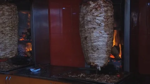 Shawarma grilling meat fried on fire slow motion footage Stock Footage 78990272