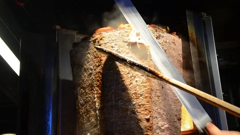 Shawarma meat being cut before making a sandwich. Doner Kebap Stock Footage 81125180