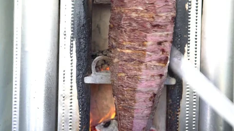 Shawarma meat being cut before making a sandwich, Turkish doner kebab Stock Footage 84884810