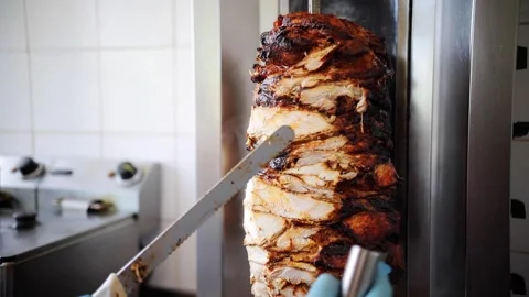 Shawarma meat being cut before making traditional Turkish Doner Kebab. Chef Stock Footage 277410266