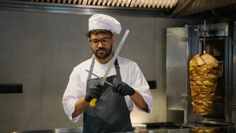 Shawarma Middle Eastern Chef Sharpening Knife in Restaurant Kitchen Stock Footage 311483335