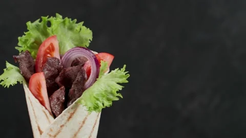 Shawarma moves on an black background. Stock Footage