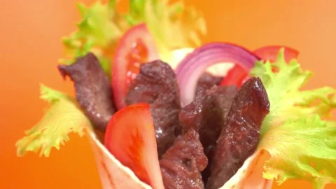 Shawarma moves on an orange background. Stock Footage 143767657