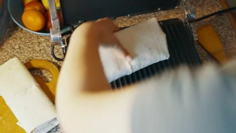 Shawarma is placed on an open hot electric grill for further cooking. Stock Footage 239997793