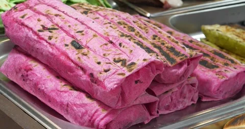 Shawarma in red dough on the store counter. Ready-made shawarma in red dough Stock Footage 279417951
