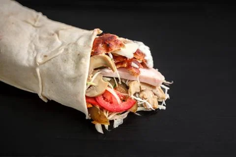 Shawarma sandwich - fresh roll of thin lavash (pita bread) filled with grille Stock Photos