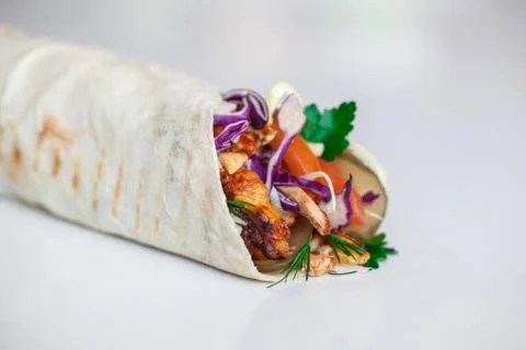 Shawarma sandwich - fresh roll of thin lavash (pita bread) filled with grille Stock Photos