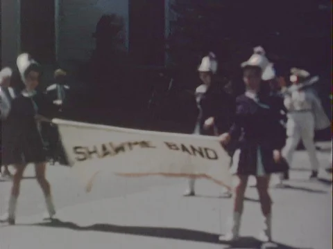 Shawme Marching Band Marching Down Street With Banner - Vintage 8mm Stock Footage 78923854