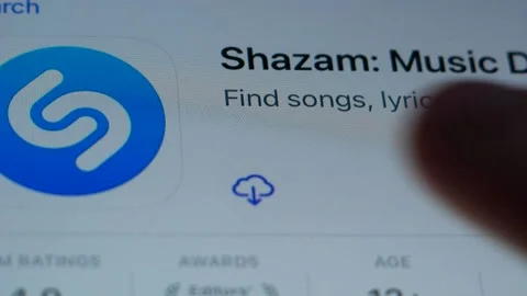 Shazam program icon on the screen of a mobile device. Installing Shazam on an iP 스톡 동영상 163040428