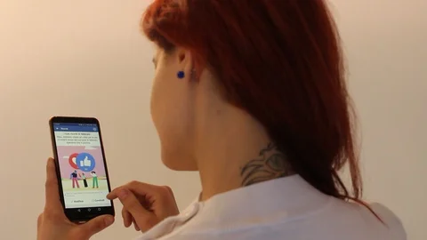 She browsing the facebook on the smartphone. Stock Footage 104819407