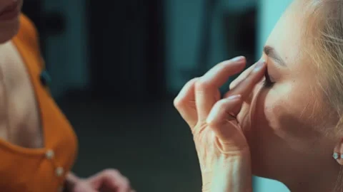 She brushes her eyebrows into shape. Small details create a polished and express Stock Footage 308747937