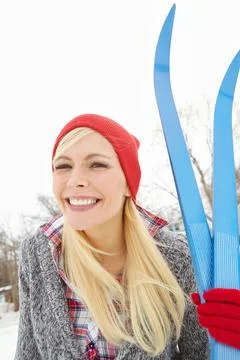 She cant wait to hit the slopes. Portrait of a young woman holding ski equipment Stock Photos