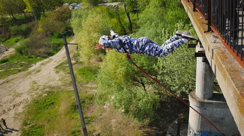 She climbs over the railing of the bridge and jumps Stock Footage 68350900