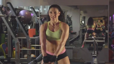 She crouches down and picks up a weight over her head Stock Footage 70321546