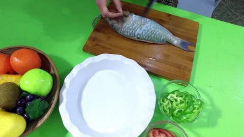 She cuts the fish. Stock Footage 76686256