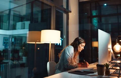 She delivers her best and more. a young businesswoman using a computer during a Stock Photos