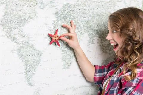 She Enjoys Looking at the Map with a Starfish Stock Photos