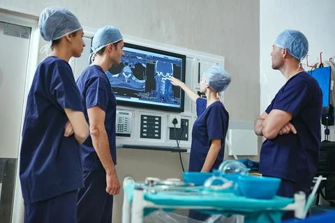 She figured out whats wrong. a team of surgeons discussing a patients medical Stock Photos