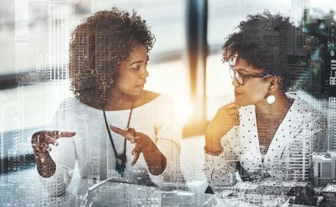 She has great ideas. two young female designers working in a modern office. Stock Photos