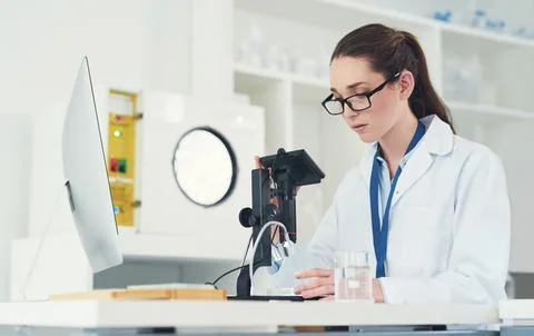 She has her work cut cut out for her. a focused young female scientist looking Stock Photos