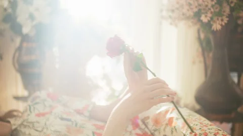 She is holding a red rose Stock Footage 128868125