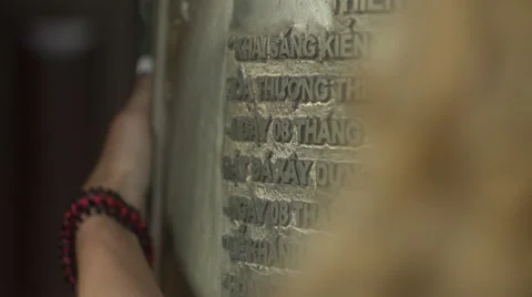 She holds her hand over the sacred bell 스톡 동영상 63047653