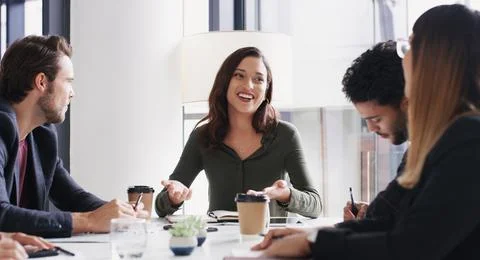 She knows how to simplify success for her team. a group of businesspeople having Stock Photos
