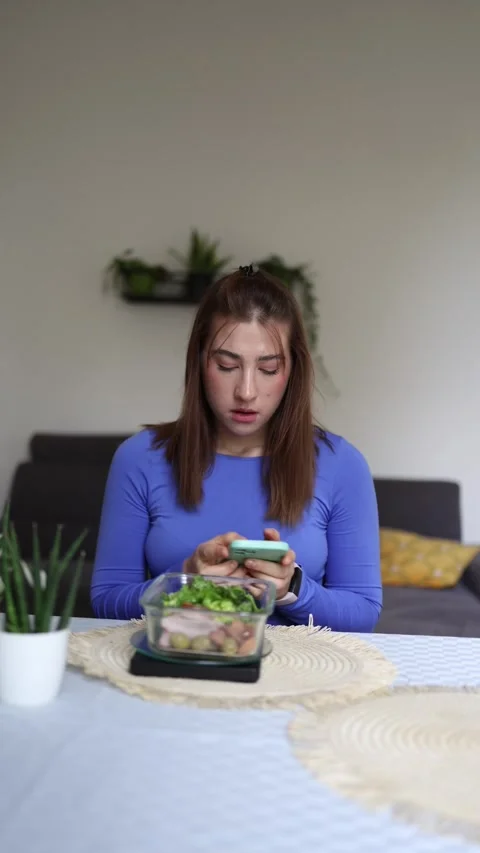She logs calories before every bite Stock Footage 339855199