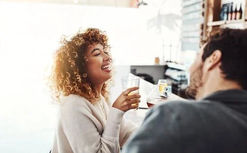 She loves a guy that can make her laugh. a happy young man and woman having Fotos de archivo