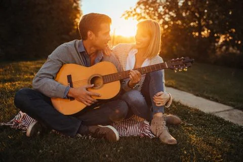 She loves when he is playing lovely songs Stock Photos