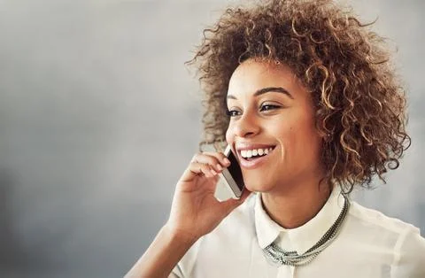She makes every client a priority. an attractive young businesswoman making a Stock Photos