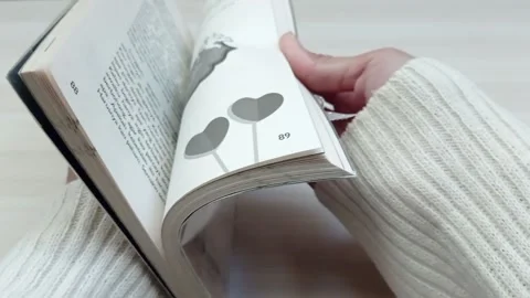 She open the book quickly Stock Footage 139429895