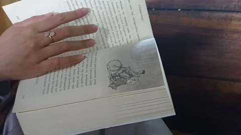 She opened the book education Stock Footage 139429787