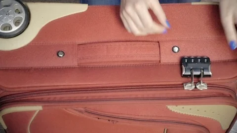 She opens the suitcase. Podbirat code to the lock Stock Footage 73031615