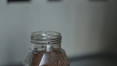 She picks up coffee from a jar with a spoon Stock Footage 91032340