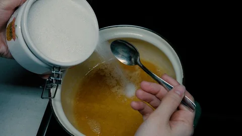 She pours sugar into a saucepan Stock Footage 127699638