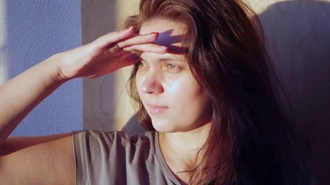 She put her hand to her eyes from the bright sun, that would look into the Stock Footage 71580156
