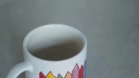 She puts the coffee in the cup Stock Footage 91032393