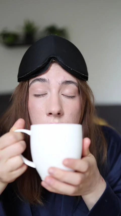 She reaches for coffee before fully waking up Video stock 340087310