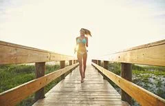 Fun in the sun. a young woman in a bikini on a walkway near the