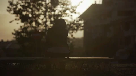 She stay on a bench in backlight Stock Footage 230666082
