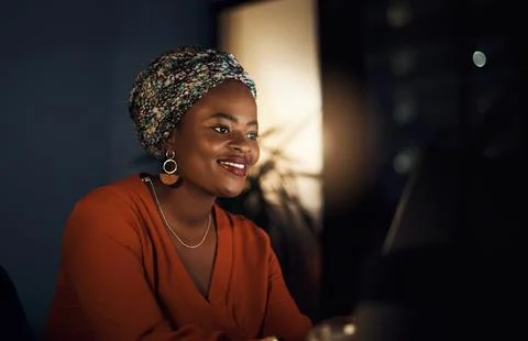 She stayed the night to work on her goals. a young businesswoman working in an Stock Photos