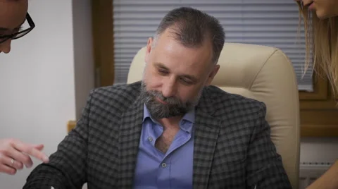 She submits to his chief assistant documents for signature. She behaves Stock Footage 63056013