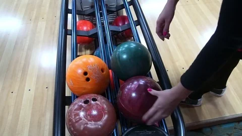 She takes the bowling ball. Stock Footage 70162810