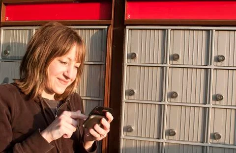 She is Texting and getting the Mail Stock Photos