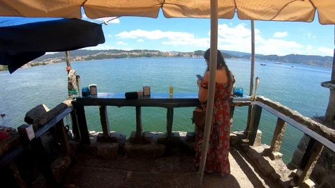 SHE IS USING THE SMARTPHONE IN FRONT THE SEA Stock Footage 92639965