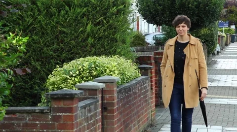 She walks down the street, she smiles. Stock Footage 68079585
