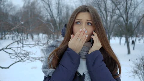 She warms his hands at winter standing in the snow. Full hd video Stock Footage 101395149
