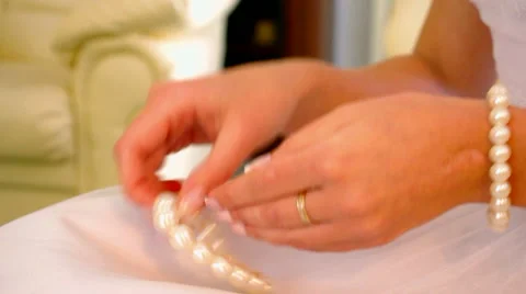 She wears bracelets on the arm Stock Footage 58092382